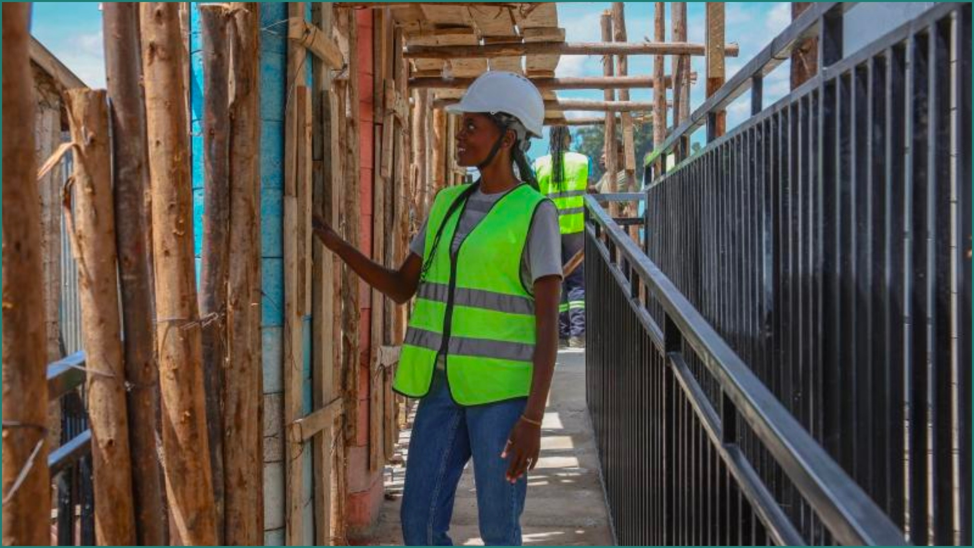 Woman inspects construction work.