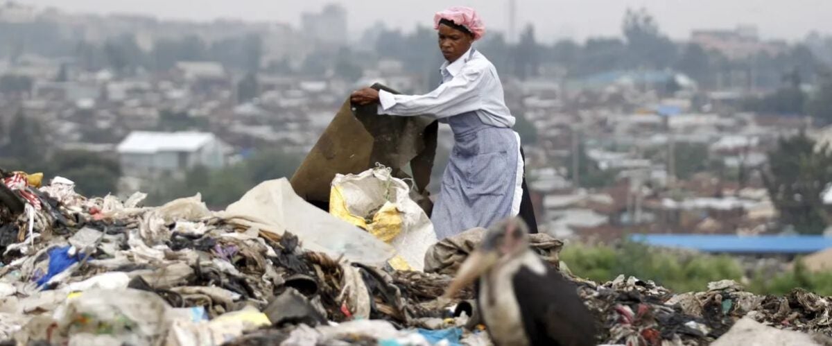 A woman scavenges for recyclable materials at the Dandora dumping site on the outskirts of Nairobi. (Image: Reuters/Thomas Mukoya)