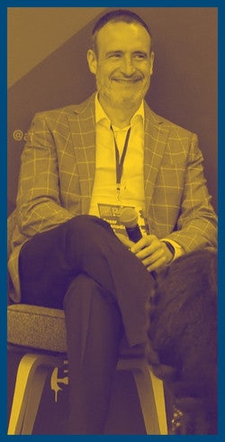 Cesar Buenadicha sitting, under a yellow filter