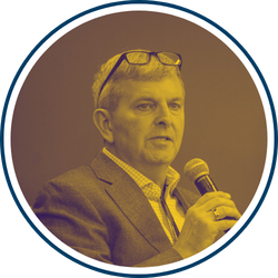 William Warshauer, President and CEO of TechnoServe, with a yellow filter.